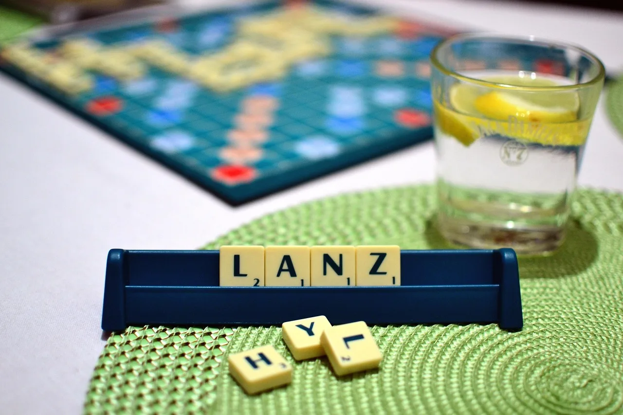 Wooden letter tiles scattered across a table, the raw material of every letter-wheel word puzzle